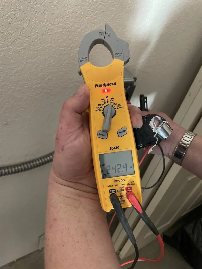 Voltage testing with clamp meter during Outlet Installation in West Hartford